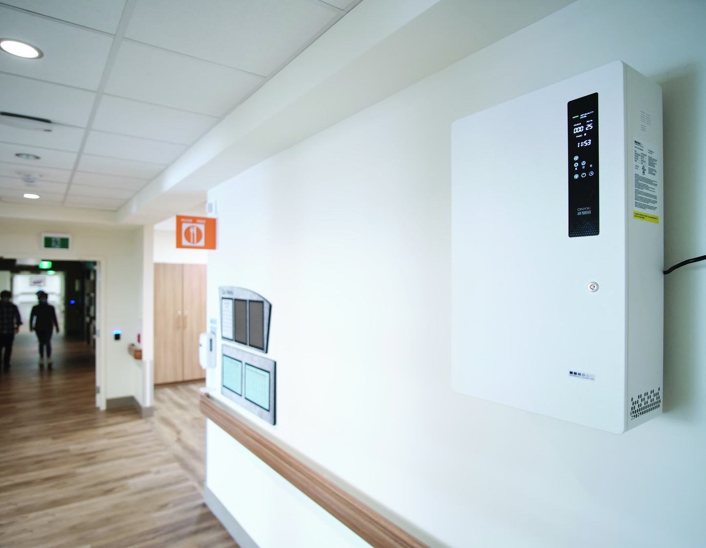Surgically Clean Air ONYXsca wall-mounted in a clinic corridor, showing its slim profile against the wall